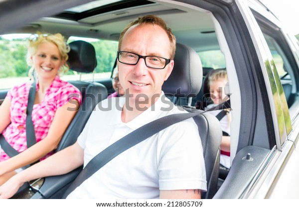 Family driving in\
car with seat belt\
fastened