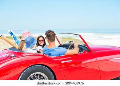 Family Driving Convertible To Beach