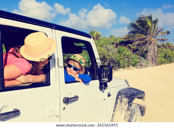 family driving off-road car on tropical beach,\
vacation concept