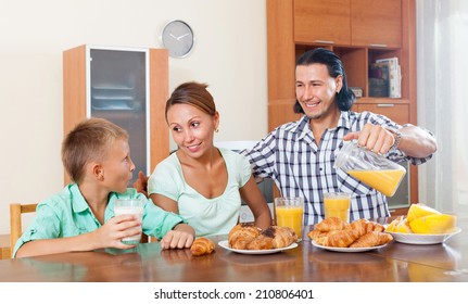 Family Eating Breakfast In Home Interior