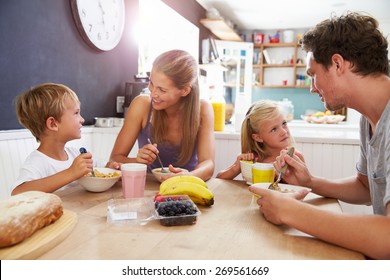 Family Eating Breakfast At Kitchen Table