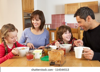 Family Eating Breakfast Together In Kitchen