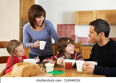 Family Eating Breakfast Together In Kitchen