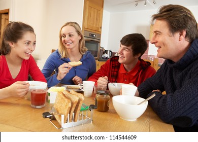 Family Eating Breakfast Together In Kitchen