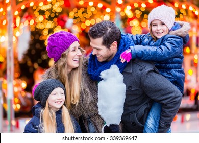 Family Eating Cotton Candy On Christmas Market