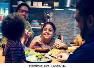 Family eating at the dining table together - Powered by Shutterstock