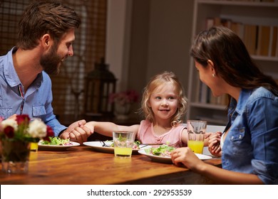 Family Eating Dinner At A Dining Table