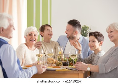 Family Eating Easter Dinner, Sitting Together Beside Table