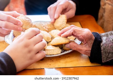 Family Eating Eid Sweets And Drinking Arabic Coffee