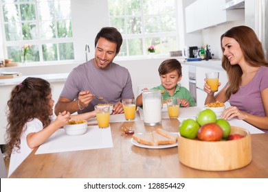 Family Eating Healthy Breakfast In Kitchen