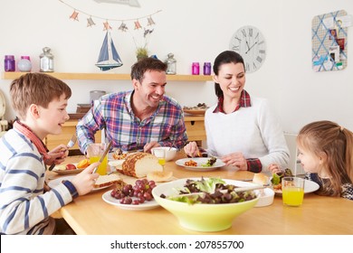 Family Eating Lunch At Kitchen Table