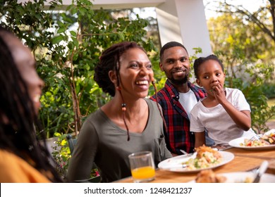 A Family Eating Lunch Together On A Patio