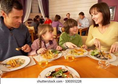 Family Eating Lunch Together In Restaurant