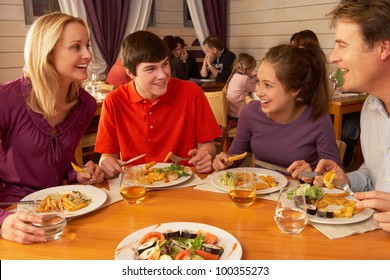 Family Eating Lunch Together In Restaurant