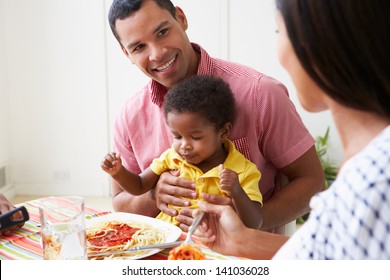 Family Eating Meal Together At Home