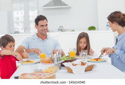 Family Eating Pasta With Sauce For The Dinner