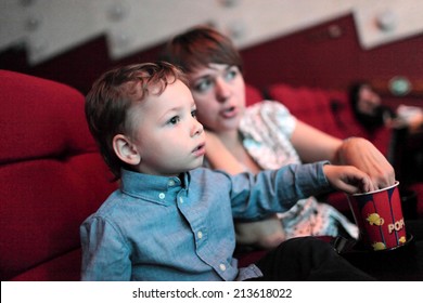 The Family Eating Popcorn In The Cinema