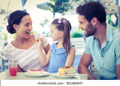 A Family Eating At The Restaurant On A Sunny Day