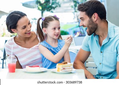 A Family Eating At The Restaurant On A Sunny Day