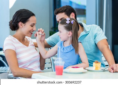 A Family Eating At The Restaurant On A Sunny Day