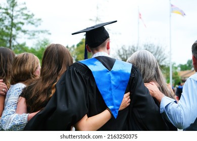 Family Embraces Recent High School Graduate.