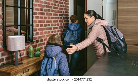 Family With Emergency Backpacks Leaving Their Front Door Quickly Due To An Emergency Evacuation