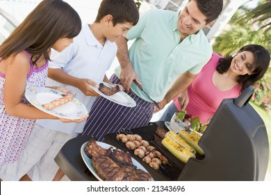 Family Enjoying A Barbeque