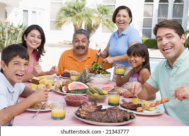 Family Enjoying A Barbeque