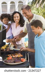 Family Enjoying A Barbeque