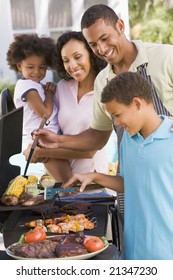 Family Enjoying A Barbeque