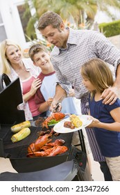 Family Enjoying A Barbeque