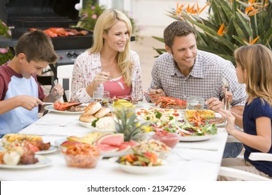 Family Enjoying A Barbeque