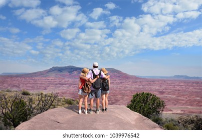 Family Enjoying Beautiful Desert Mountain Landscape On Hiking Trip. Painted Desert, Petrified Forest National Park, Arizona, USA.