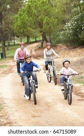 Family Enjoying Bike Ride In Park