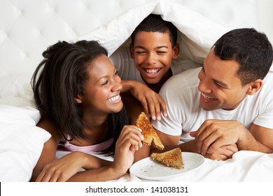 Family Enjoying Breakfast In Bed - Powered by Shutterstock