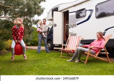 Family Enjoying Camping Holiday In Camper Van 