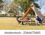 A family enjoying camping on a sunny day.