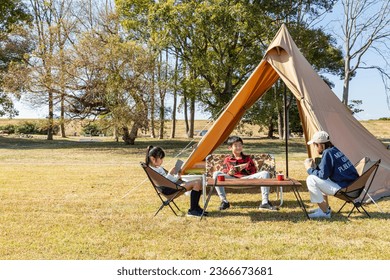 A family enjoying camping on a sunny day. - Powered by Shutterstock