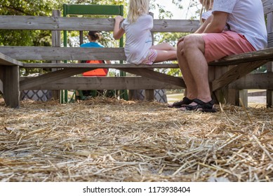 Family Enjoying A Hay Ride In Autumn