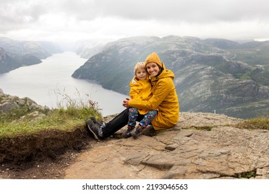 Family, Enjoying The Hike To Preikestolen, The Pulpit Rock In Lysebotn, Norway On A Rainy Day, Toddler Climbing With His Pet Dog The One Of The Most Scenic Fjords In Norway