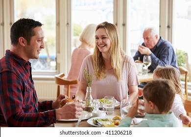 Family Enjoying Meal In Restaurant Together