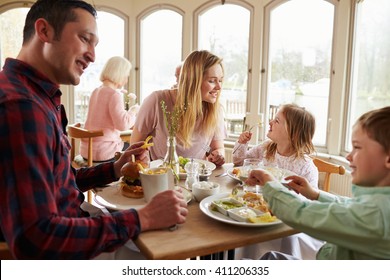 Family Enjoying Meal In Restaurant Together