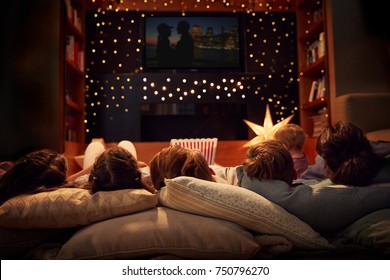 Family Enjoying Movie Night At Home Together