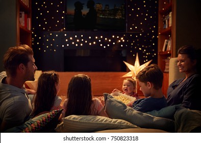 Family Enjoying Movie Night At Home Together - Shutterstock ID 750823318