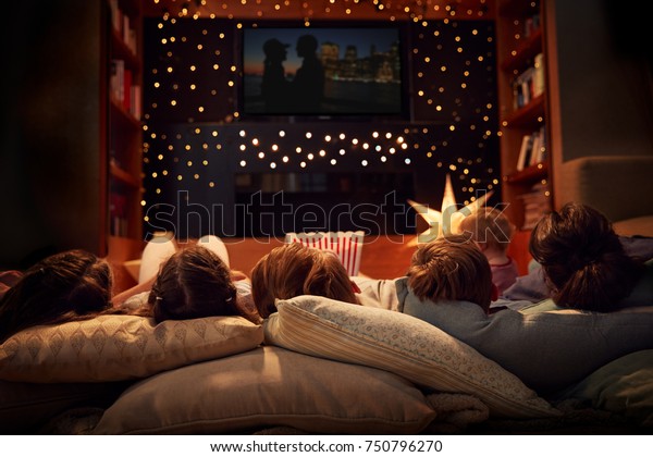 Family Enjoying\
Movie Night At Home\
Together