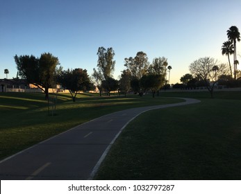 A Family Enjoying A Nice Quiet Bike Ride Along A Serene Path In Scottsdale Arizona.