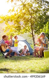 Family Enjoying On Summer Day On Camping
