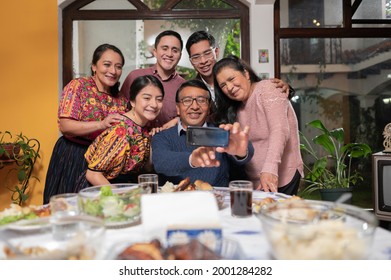 A Family Enjoying A Family Party Takes A Selfie With A Cell Phone.