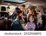 Family enjoying a road trip inside their car with kids taking photos and drinking from thermos