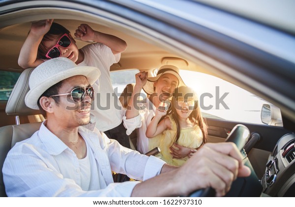 Family enjoying road\
trip and summer vacation. Happy family is riding a car to go on\
summer holidays. Father, mother and son were on their way to the\
sea or river or ocean.